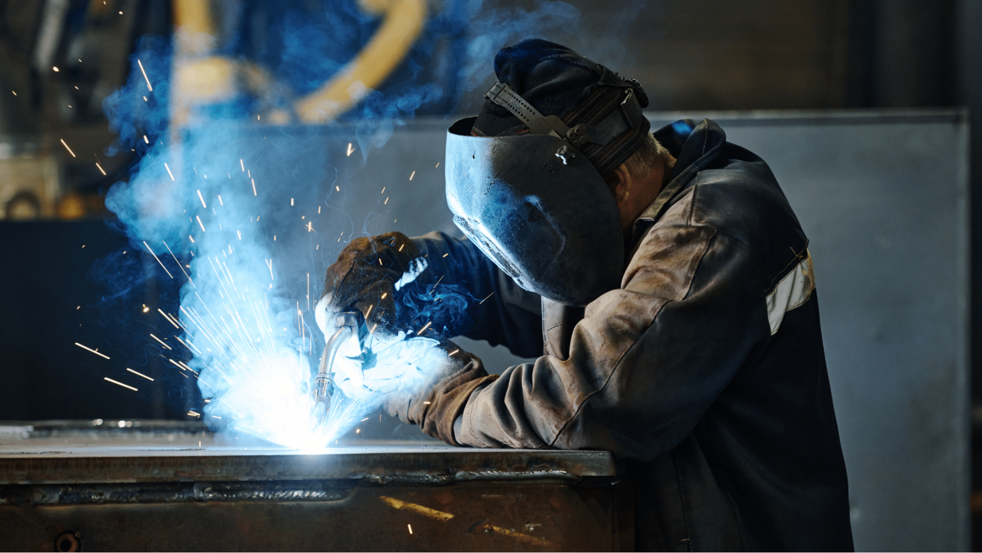 Worker refining sheet metal